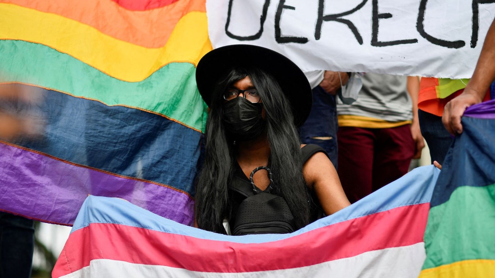 Protestor holding a pride flag.